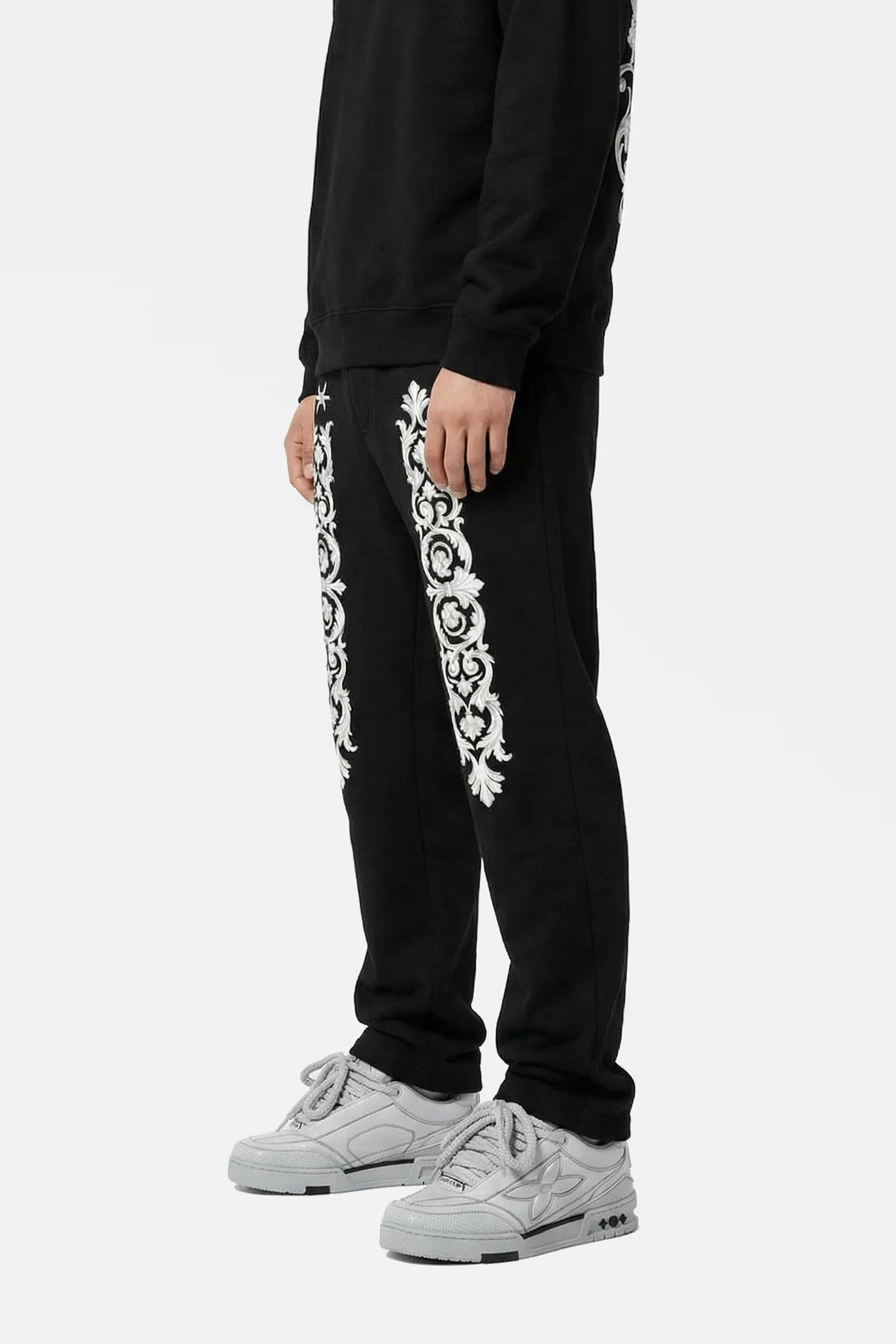 Black tracksuit with white floral patterns on a white background