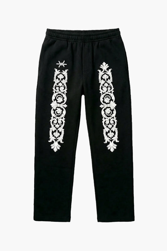 Black pants with white floral baroque patterns and 'Ominous' brand logo on a white background