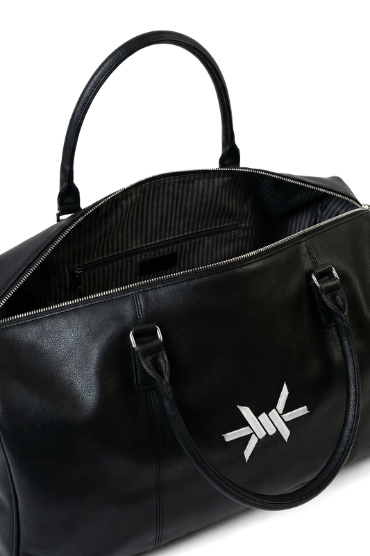 Ominous Weekender Duffel - Open black duffel bag with a zipped pocket inside with a white logo on a white background
