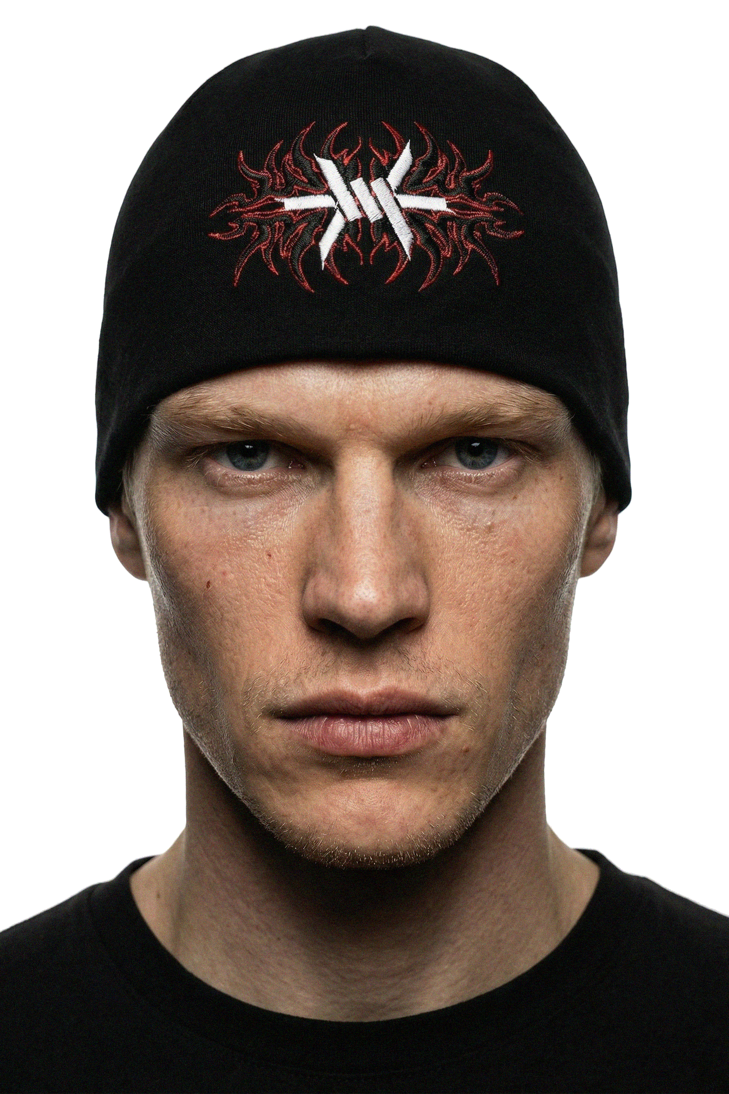 man wearing a black skully skullcap beanie with red and white 'Ominous' logo design on a white background