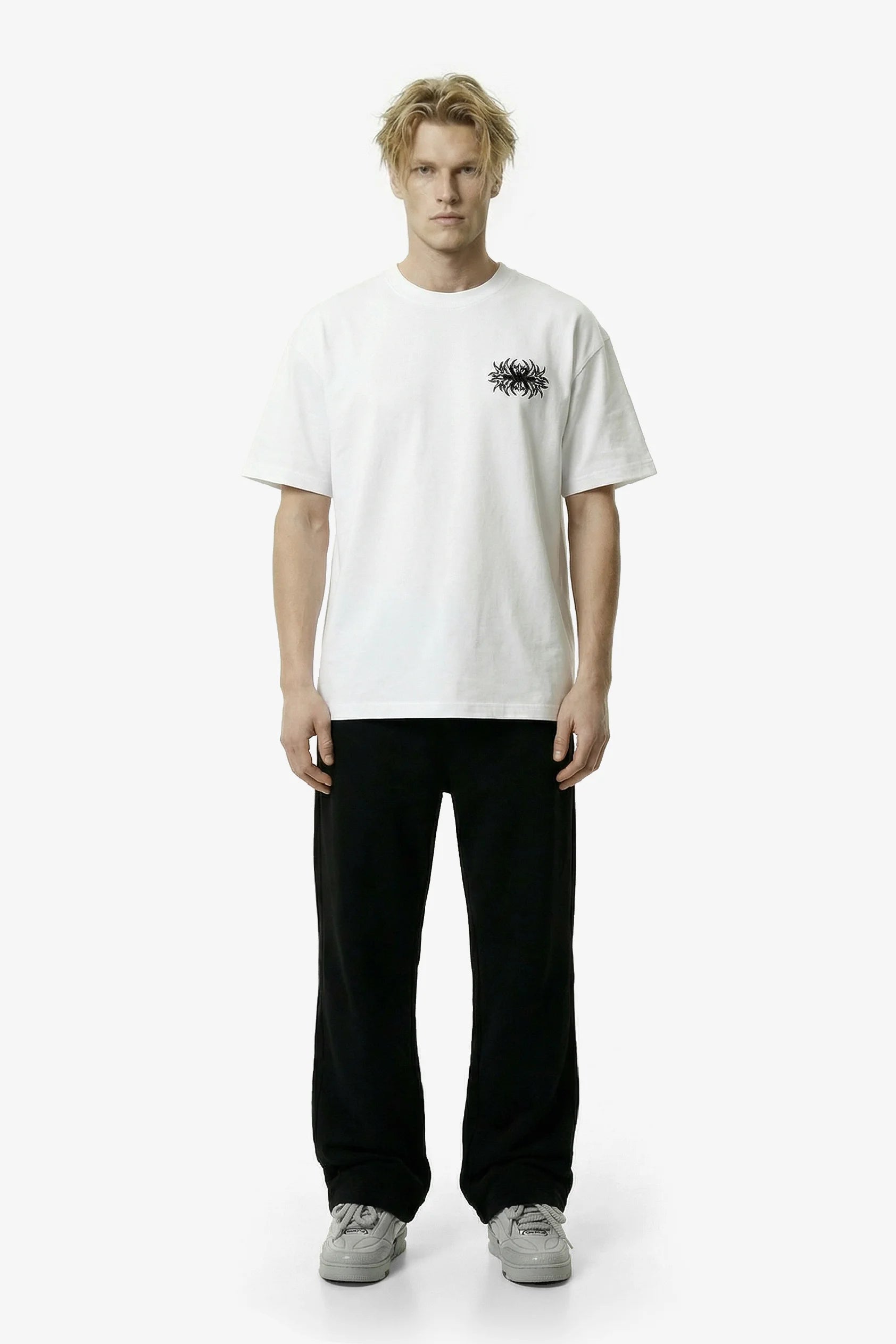 Person wearing a white t-shirt with a small black graphic on a white background